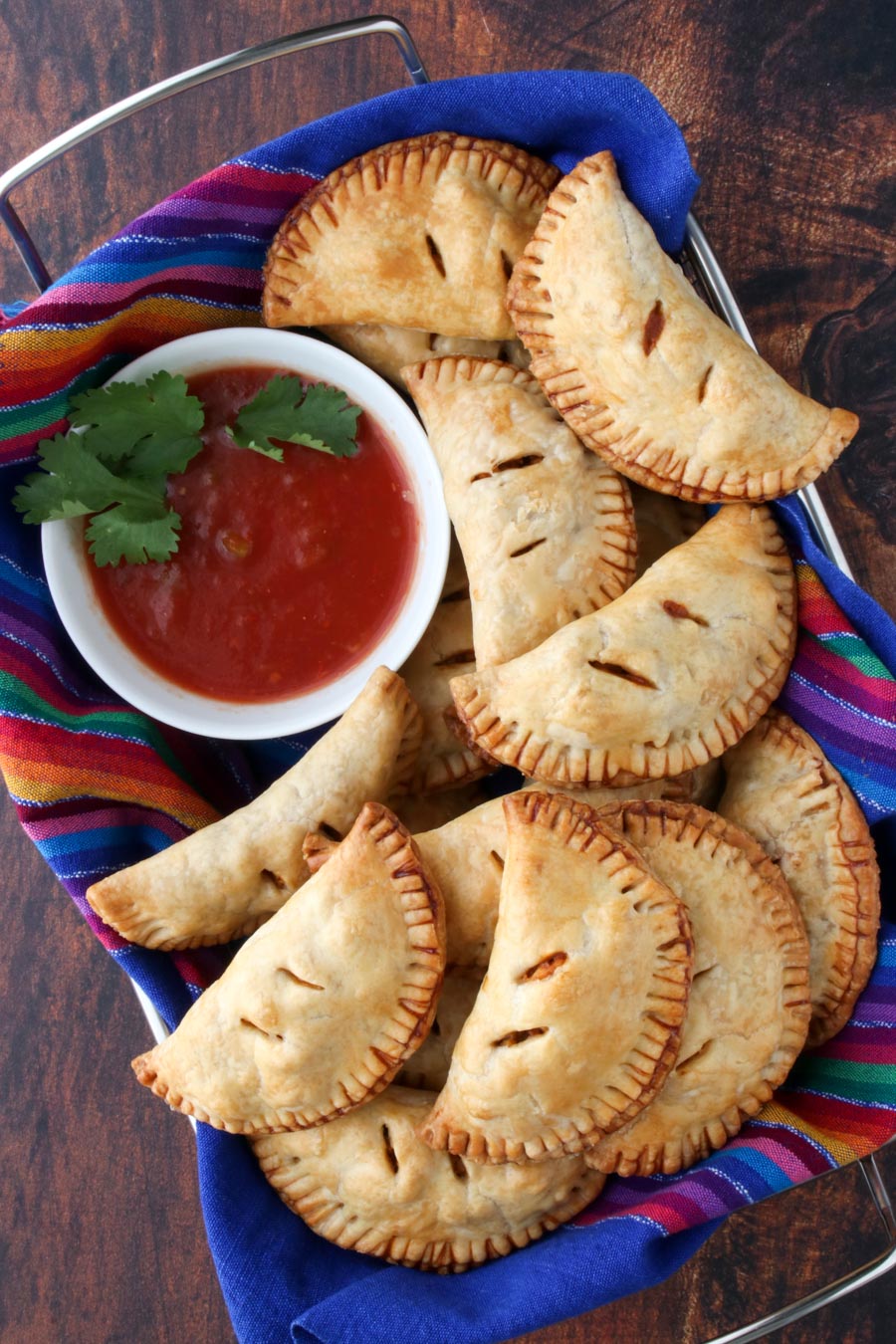 basket of empanadas and a bowl of salsa