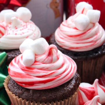 chocolate cupcake decorated with red and white swirl frosting