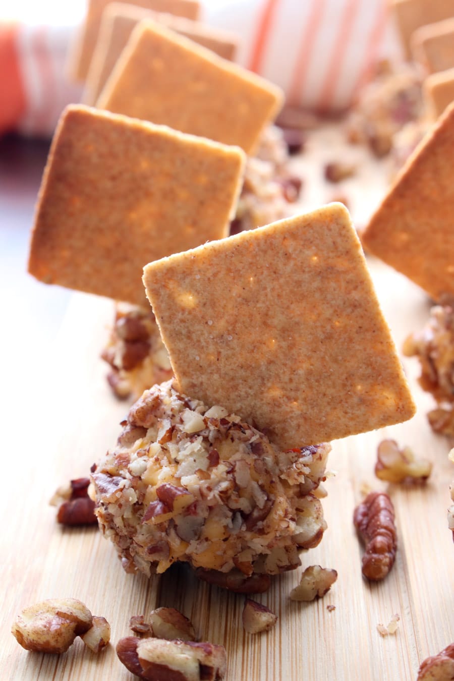 Pimento Cheese ball coated in nuts with a cracker stuck in it
