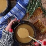 Woman's hands holding a bowl of bean soup