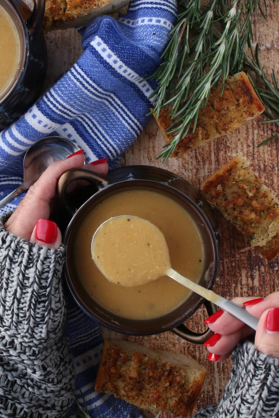 Woman's hands holding a bowl of bean soup