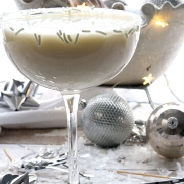 White martini with a glittery sleigh in the background