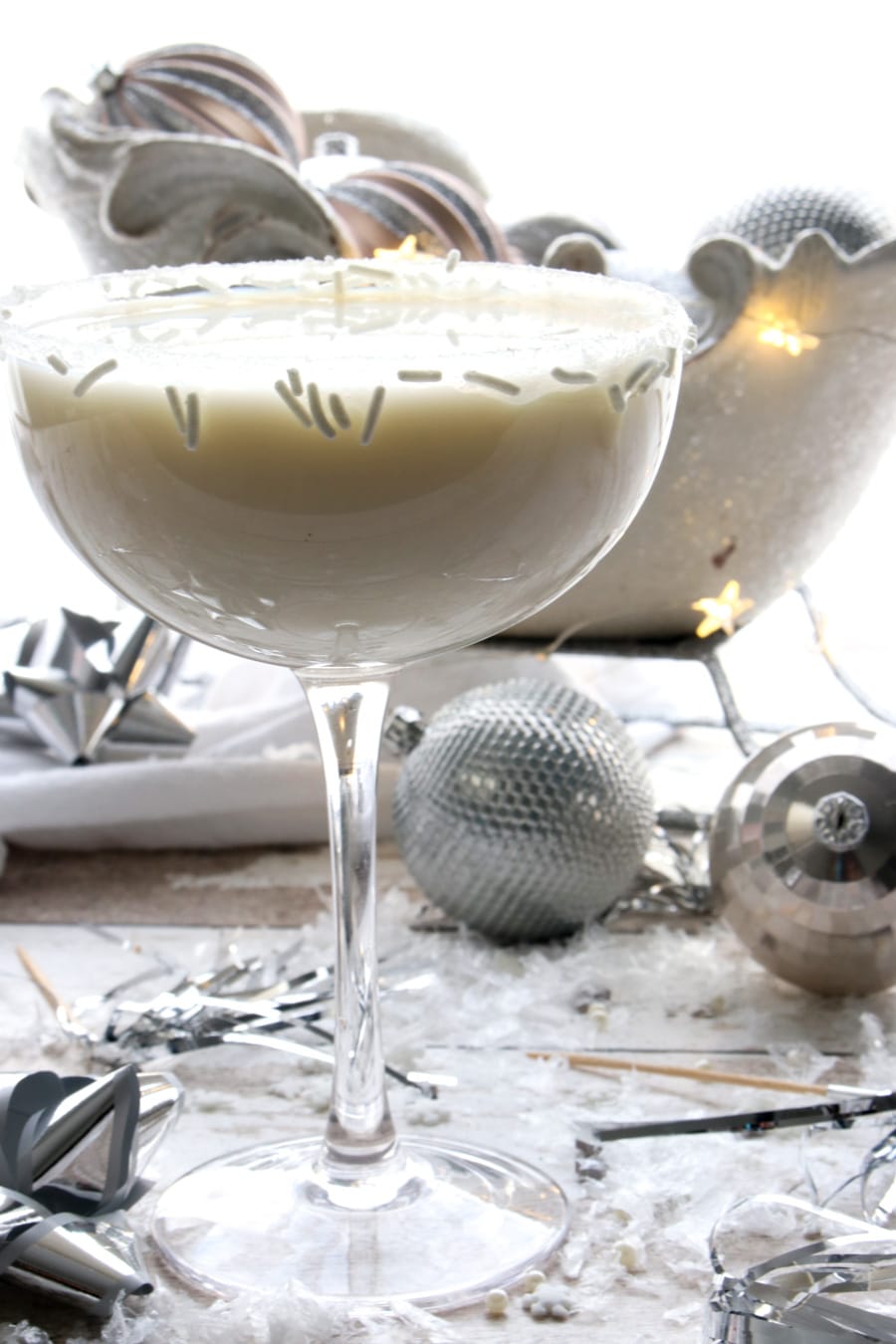 White martini with a glittery sleigh in the background