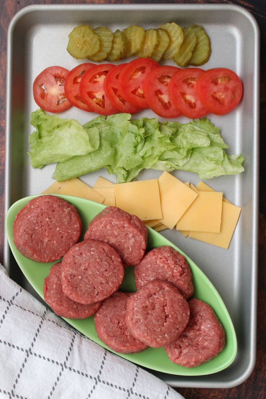 cookie sheet with the ingredients to make cheeseburger sliders