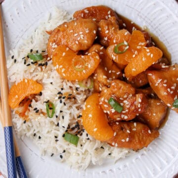 White plate with orange chicken and rice