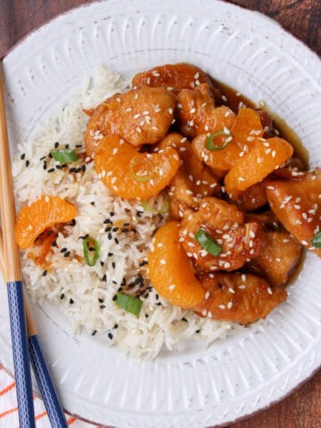 White plate with orange chicken and rice