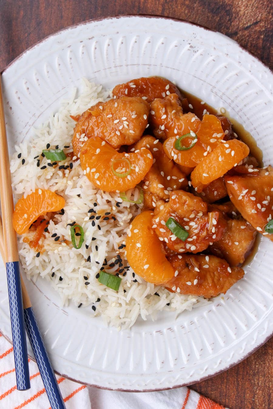 White plate with orange chicken and rice