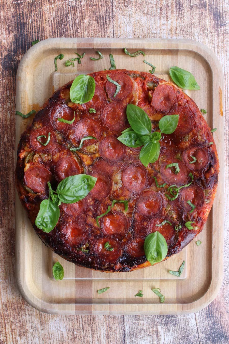 BAKED PIZZA ON A CUTTING BOARD