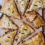 8 beef and potato hand pies on a cutting board