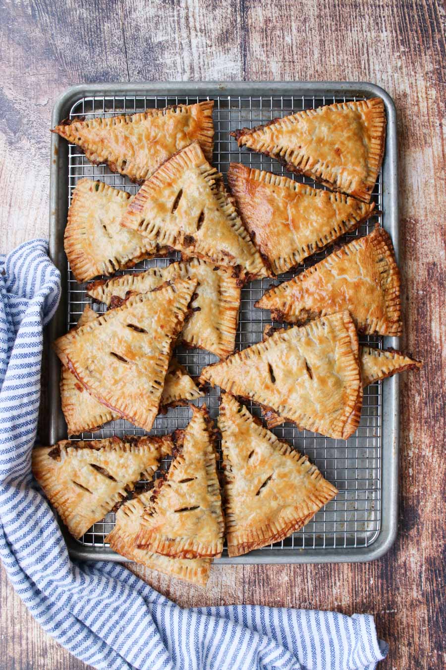 cookie sheet with a pile of hand pies