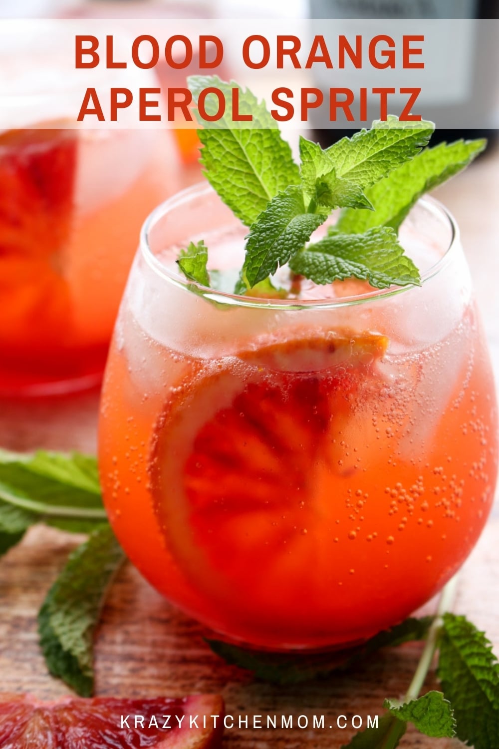 Blood Orange Aperol Spritz is a traditional Aperol Spritz made with blood orange juice and slices and then garnished with fresh mint. via @krazykitchenmom