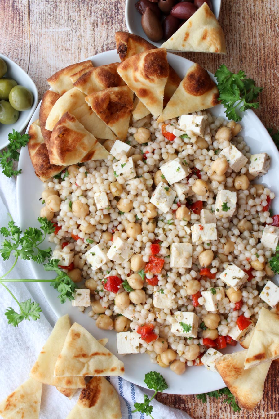 A platter of couscous salad  pita bread on the side