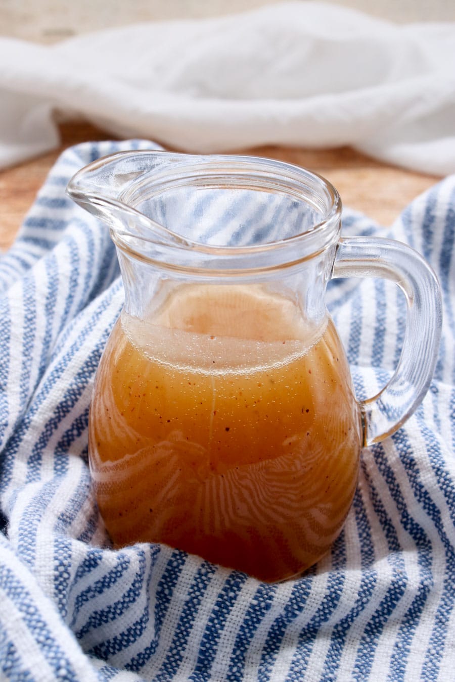 SMALL JAR OF BOURBON BUTTER SAUCE ON A BLUE AND WHITE CLOTH