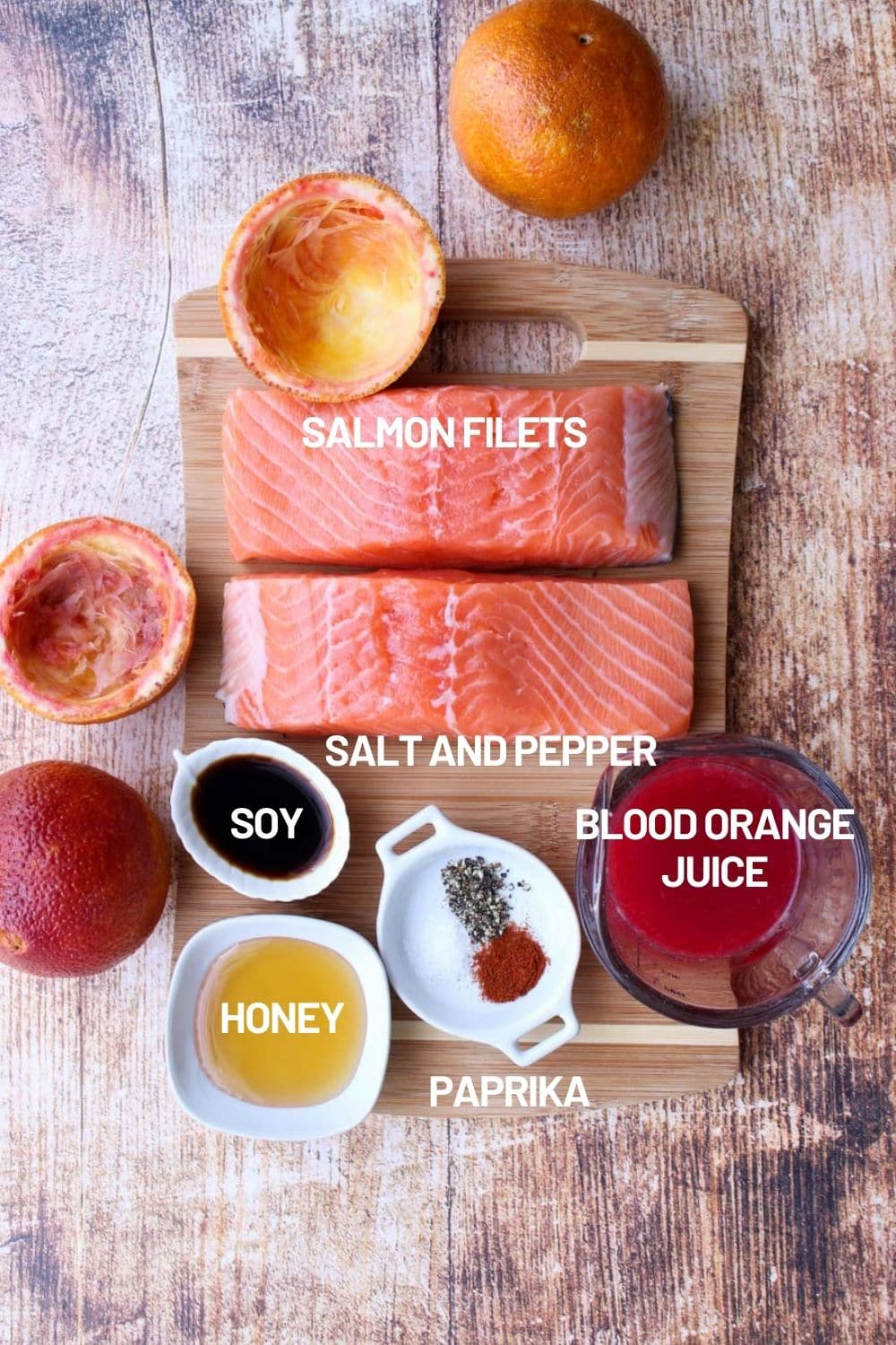 Cutting board with the ingredients to make orange glazed salmon