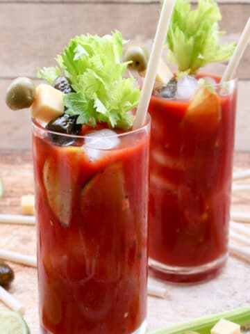 Two glasses of blood marys with celery stalks