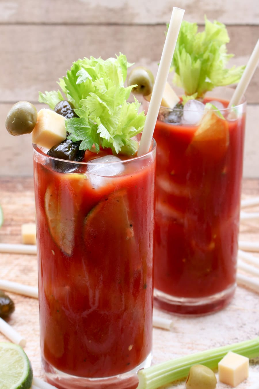 Two glasses of blood marys with celery stalks