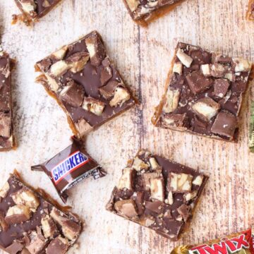 overhead shot of cookie bars and candy bars on a cutting board