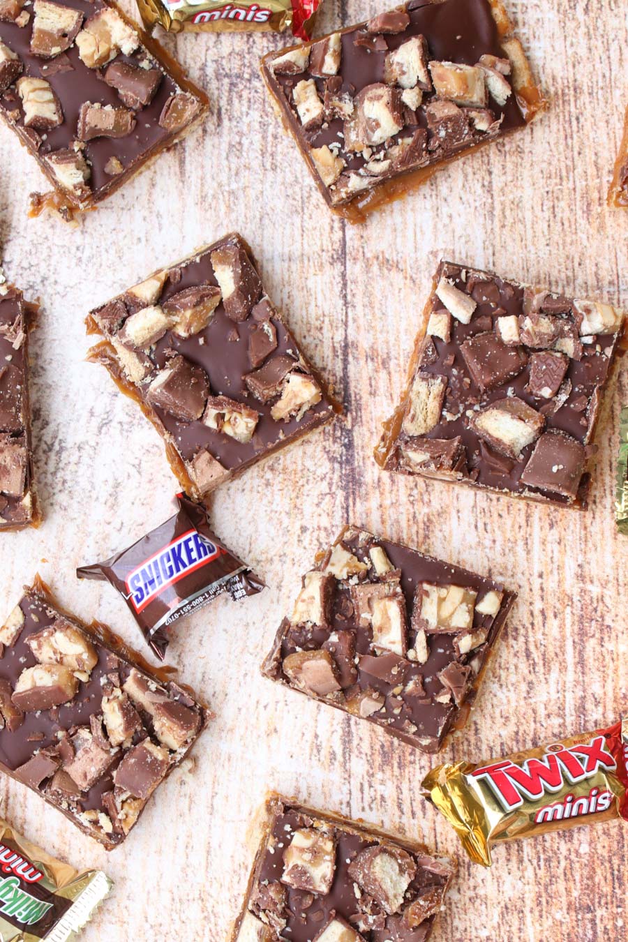 overhead shot of cookie bars and candy bars on a cutting board