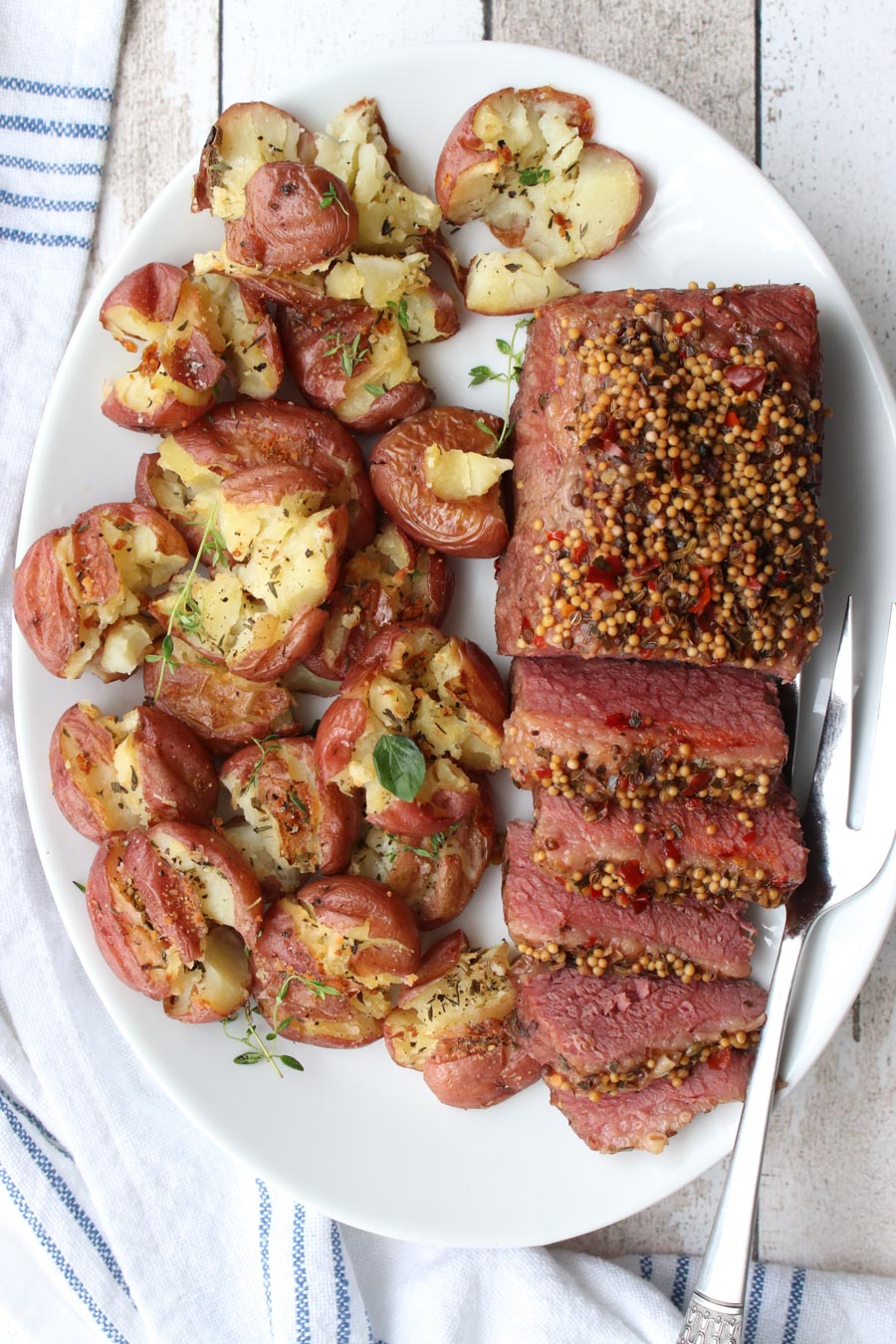 CORNED BEEF BRISKET AND POTATOES ON A WHITE PLATTER