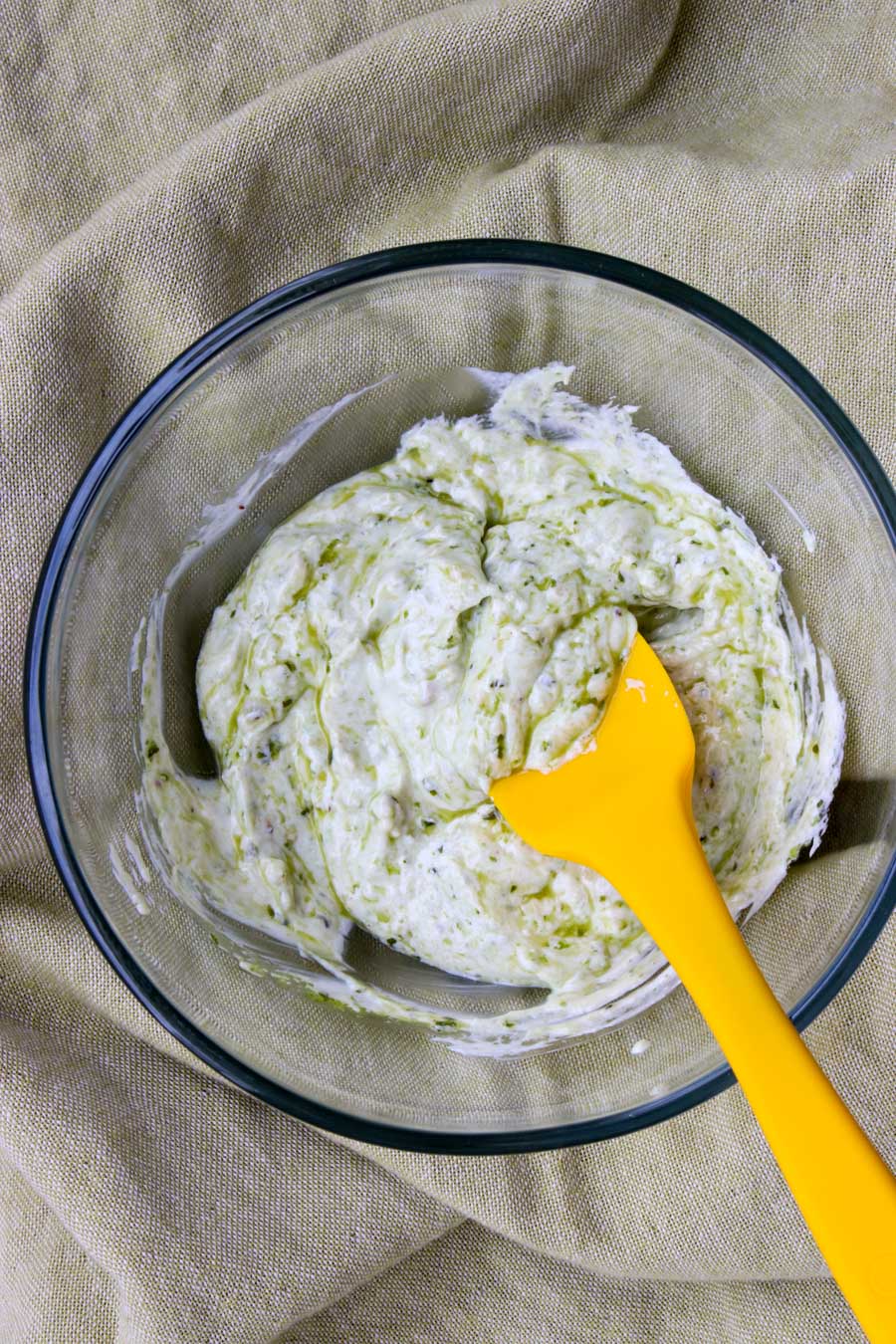 bowl of pesto yogurt dip with a yellow spook