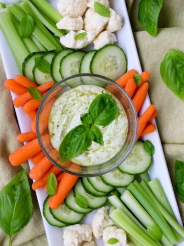 platter of veggies with a bowl of yogurt pesto dip