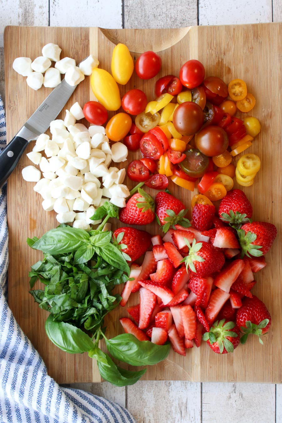 Cutting board with cypress salad ingredients diced 