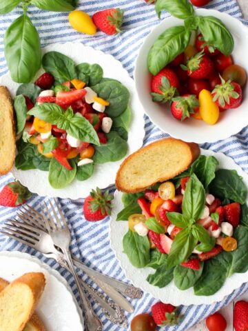 two strawberry cypress salads and a bowl of fresh strawberries