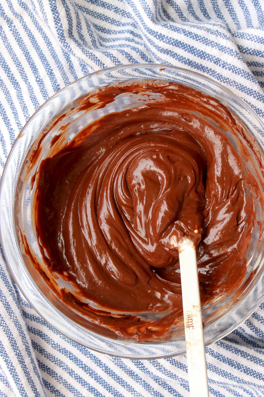 Bowl of chocolate frosting with a spatula