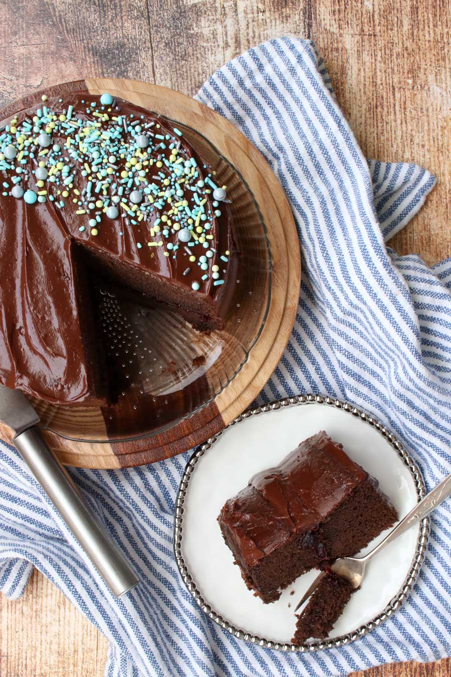 Overhead shot of chocolate cake with chocolate frosting and a slice cut out