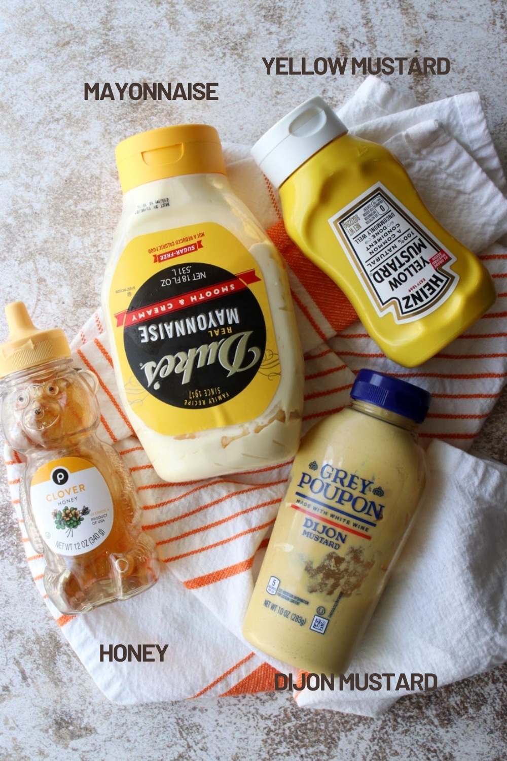 container of yellow mustard, Dijon mustard, mayo, honey