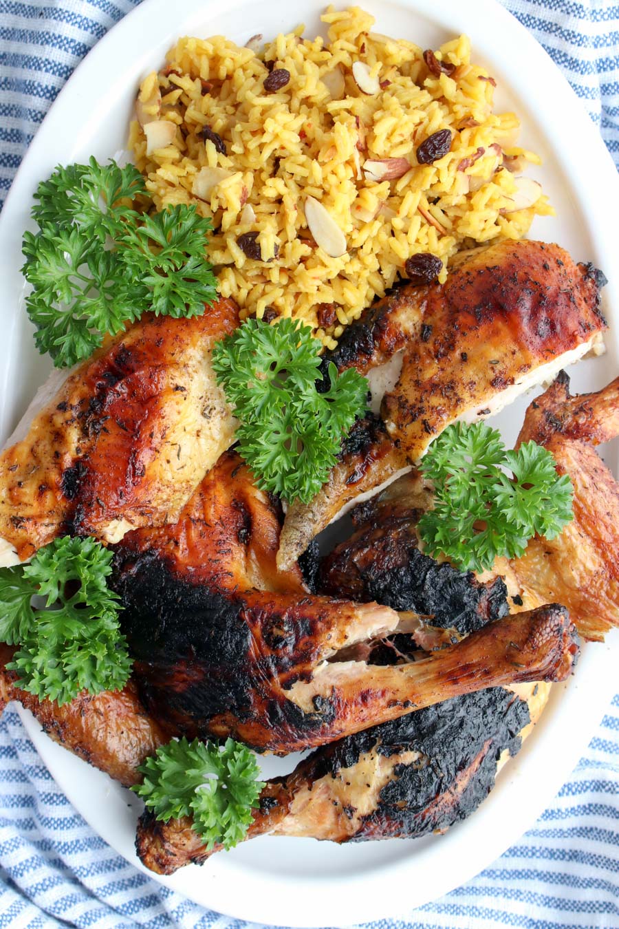 grilled chicken on a platter with yellow rice