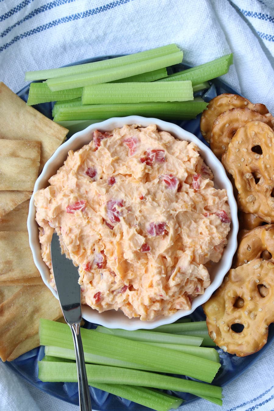 bowl of pimento cheese with crackers and celery sticks