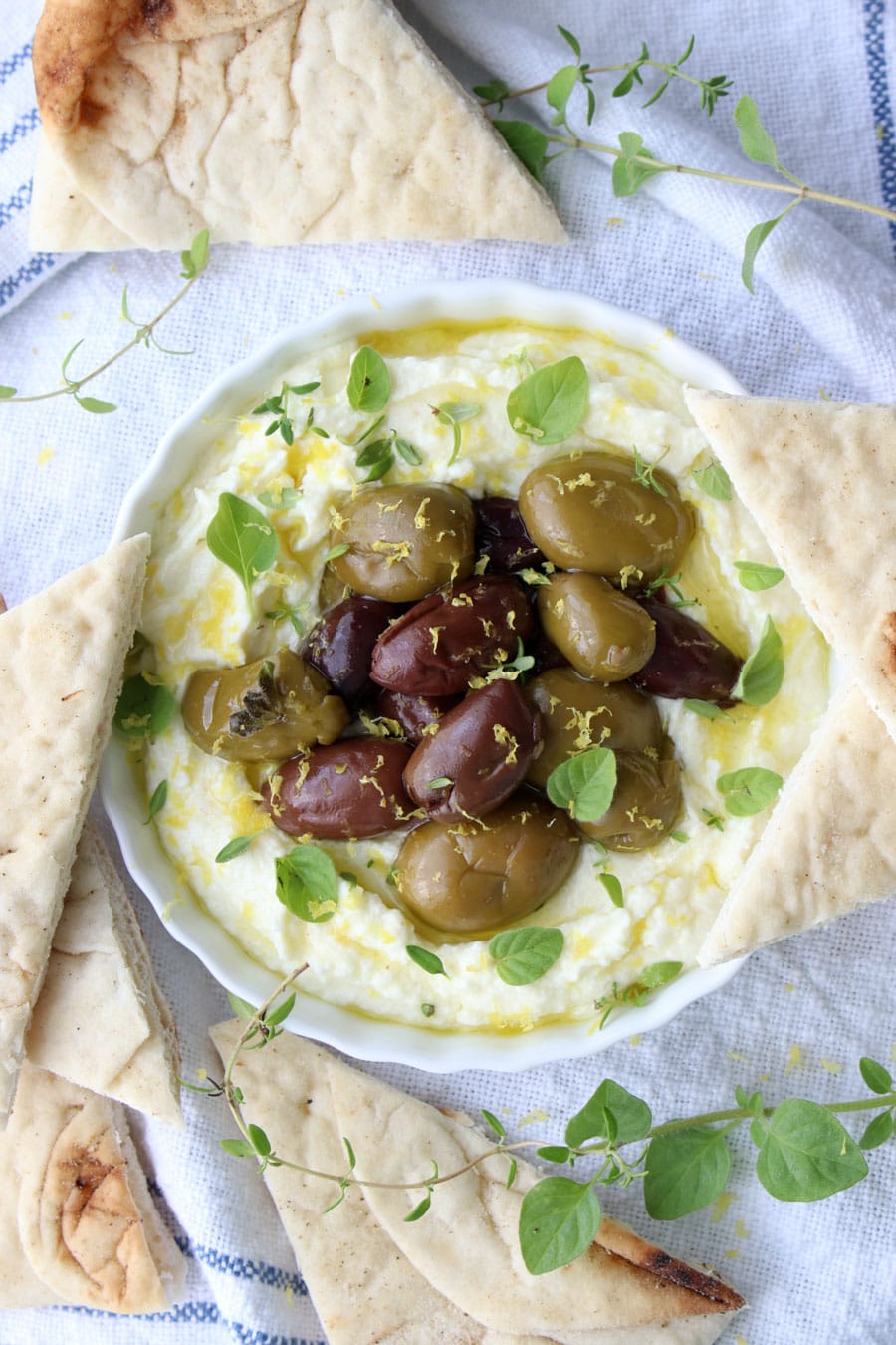 Bowl of whipped feta and olives and pita 