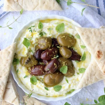 Bowl of whipped feta and olives and pita