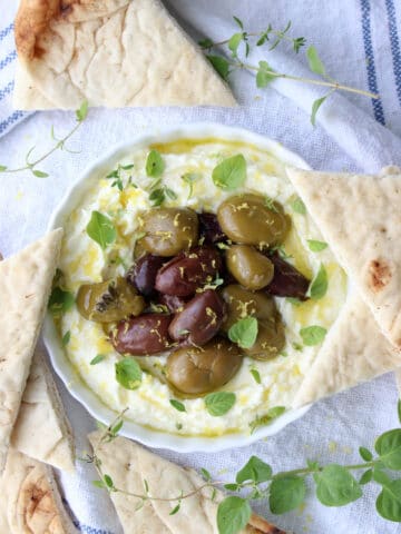 Bowl of whipped feta and olives and pita