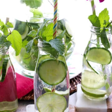 milk bottles of water with cucumber and mint