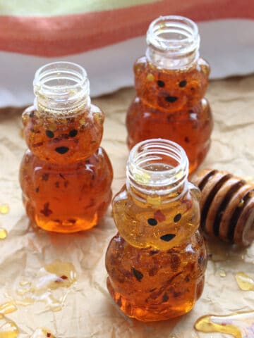 THREE SMALL BEAR JARS OF HONEY