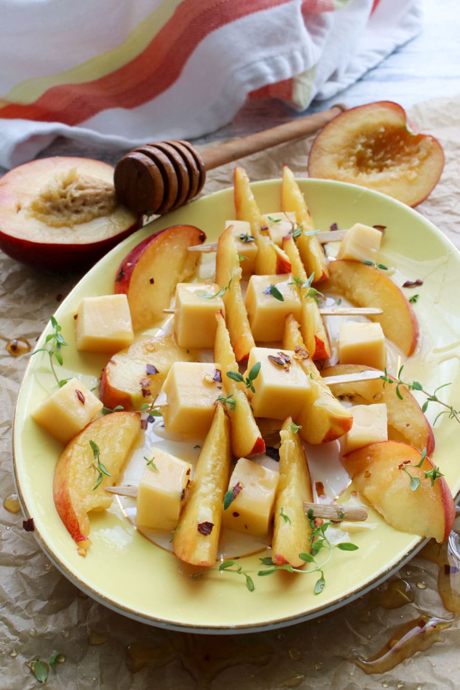 Skewers of gouda cheese, peach slices, and hot honey