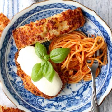 blue plate with chicken parmesan and spaghetti