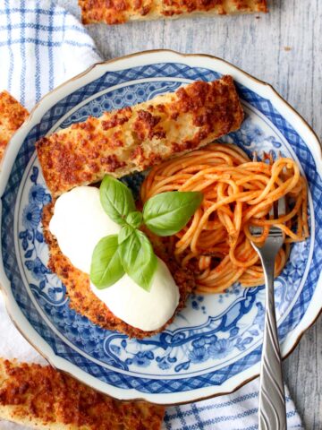 blue plate with chicken parmesan and spaghetti