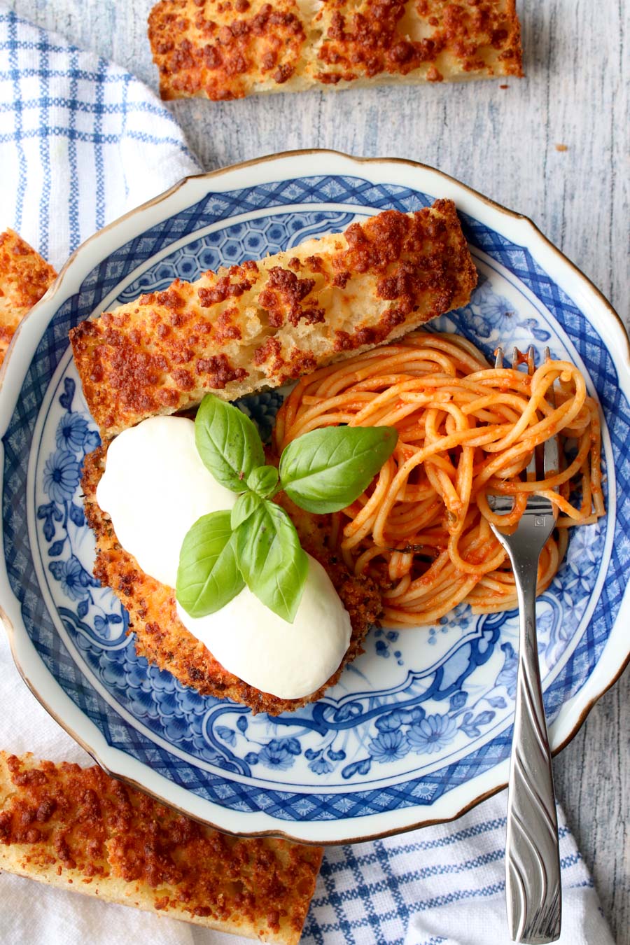 blue plate with chicken parmesan and spaghetti