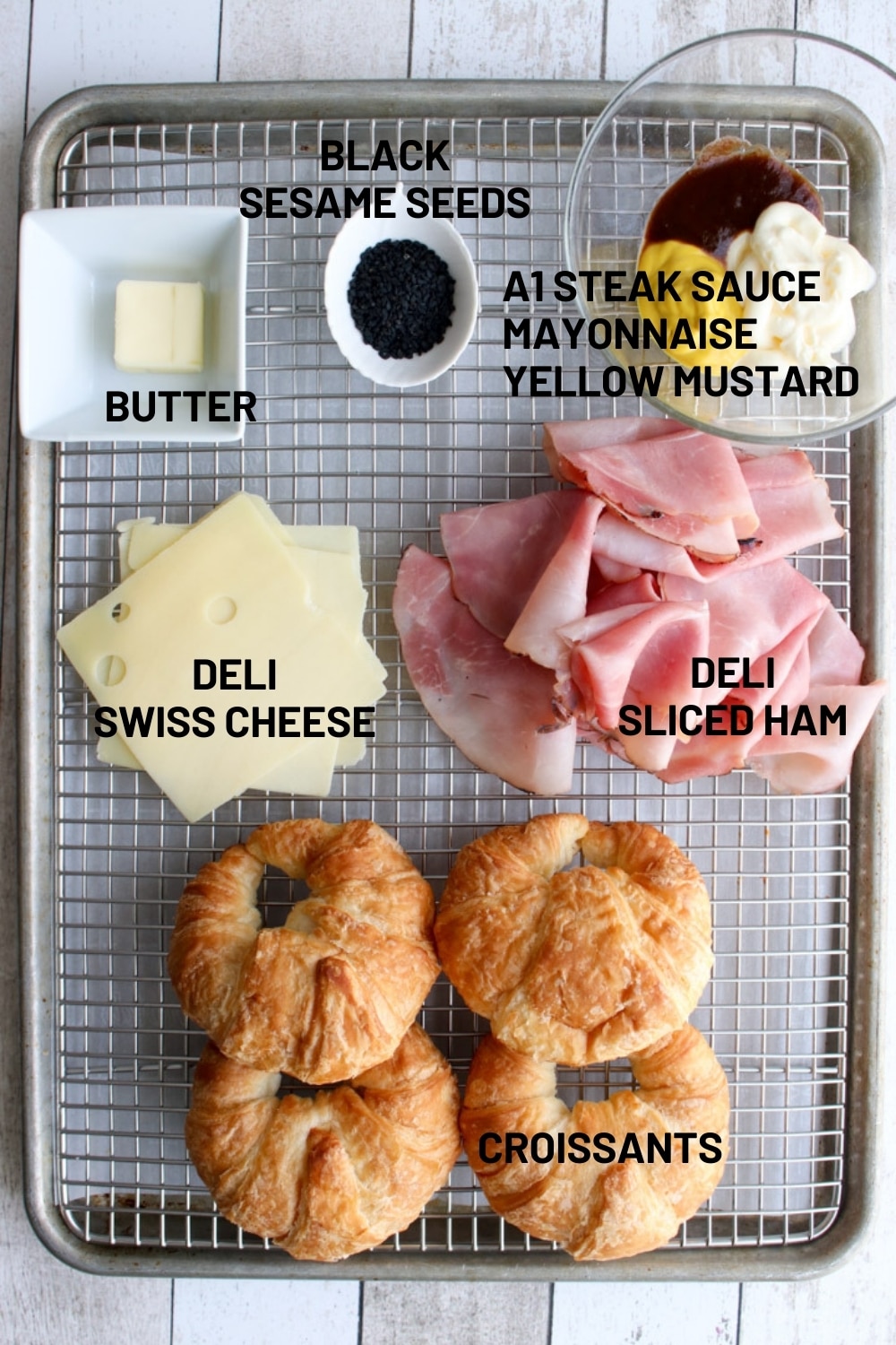 cookie sheet with ingredients to make ham and cheese croissant sandwiches