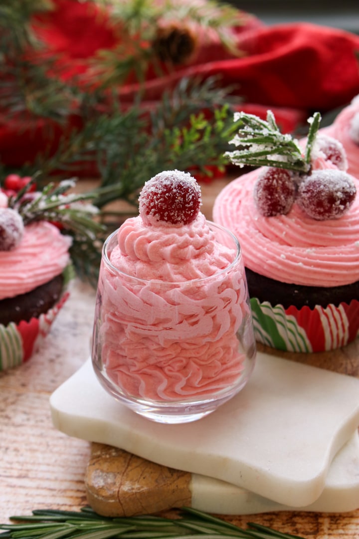 small jar filled with pink cranberry buttercream frosting