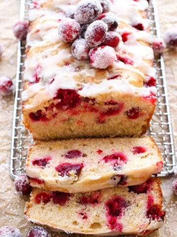 cranberry orange coffee cake with several slice laying in front