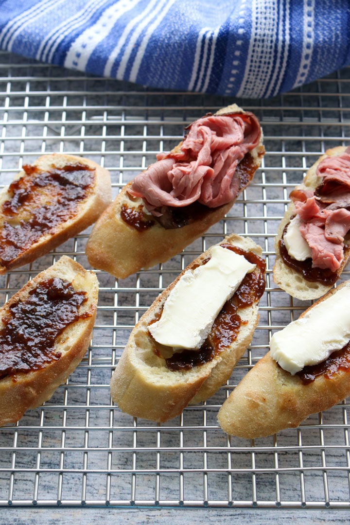 crostinis on a cookie sheet showing how to assemble