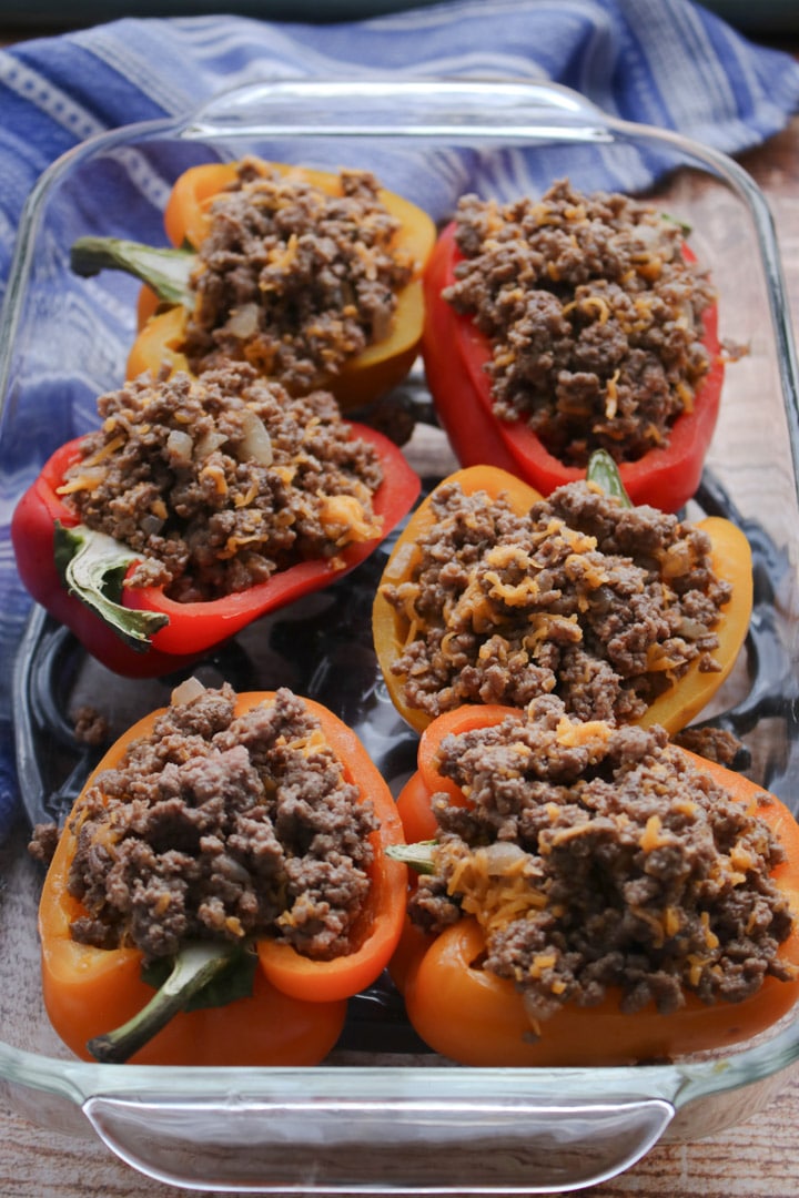 cheeseburger stuffed peppers in a clear baking dish