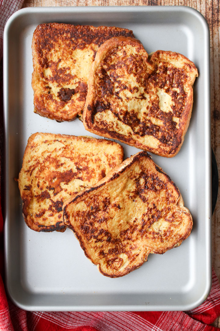 four slices of french toast on a cookie sheet