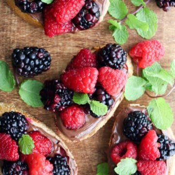 wooden serving board with hazelnut berry toasts