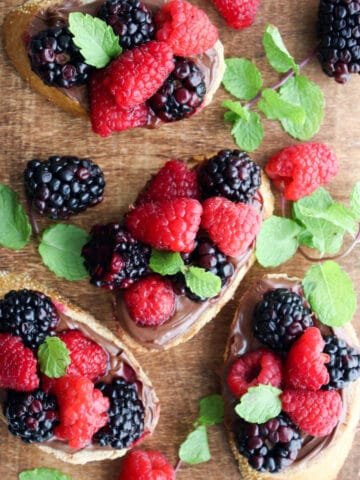 wooden serving board with hazelnut berry toasts