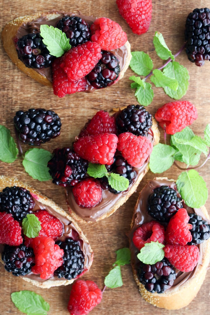 wooden serving board with hazelnut berry toasts